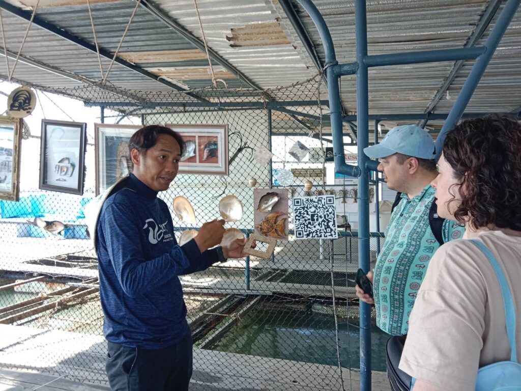 Amorn Pearl Farm tour guide explaining to guests
