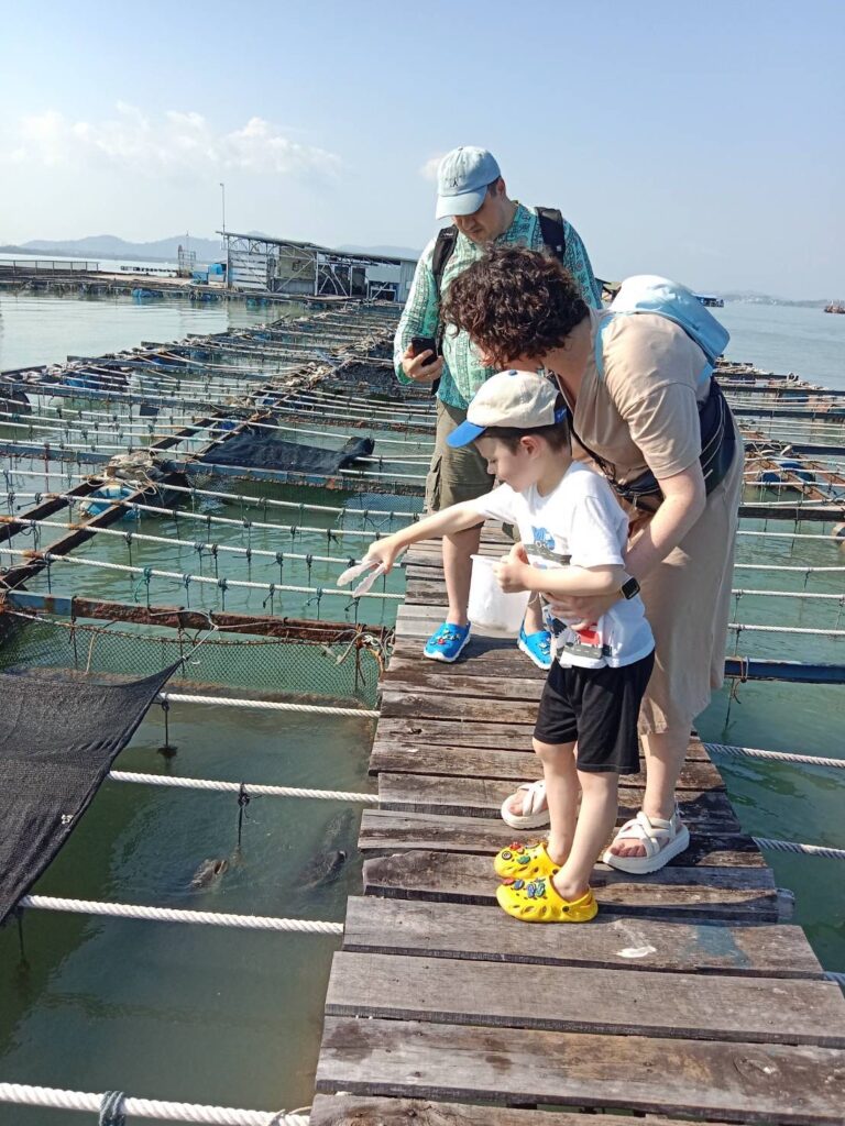 A family showing a child oysters being farmed