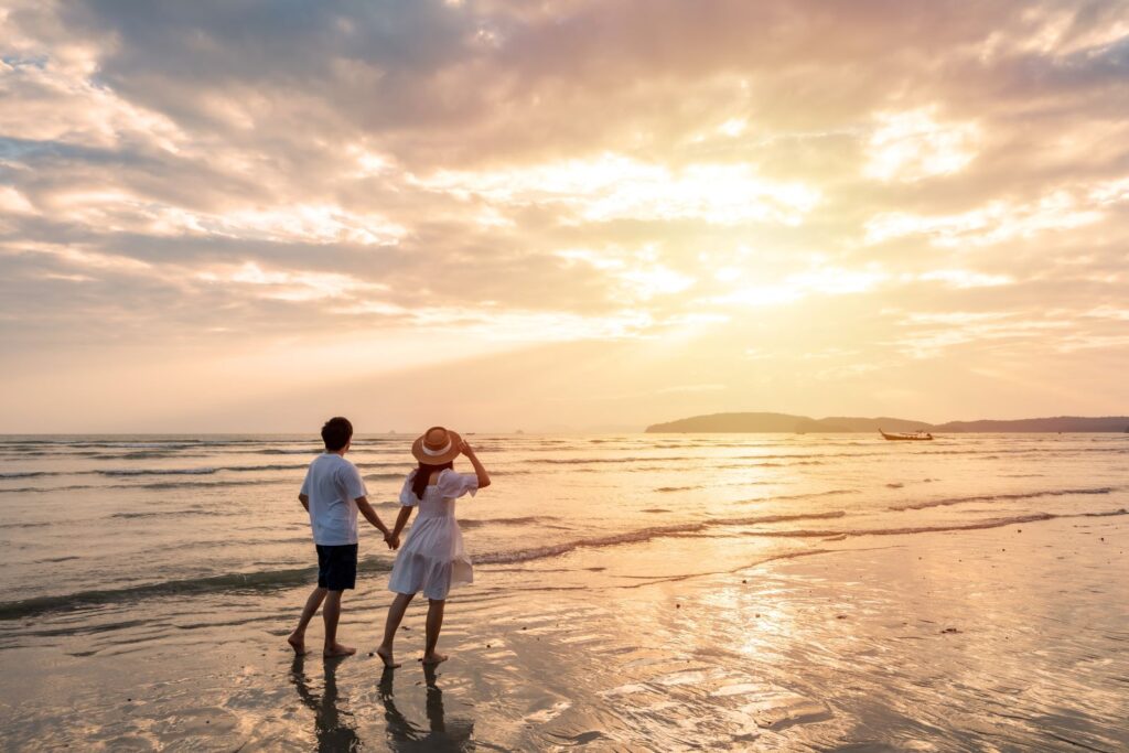 A couple watching the sunset on a beach
