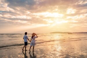 A couple watching the sunset on a beach