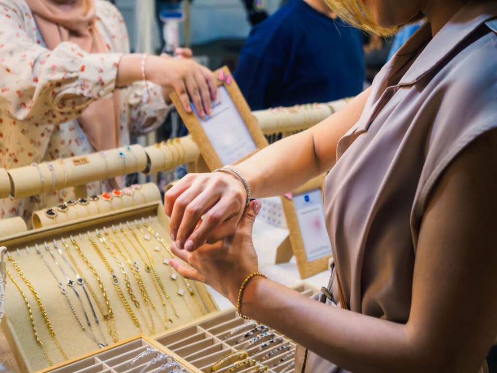 A woman trying on a bracelet in a market