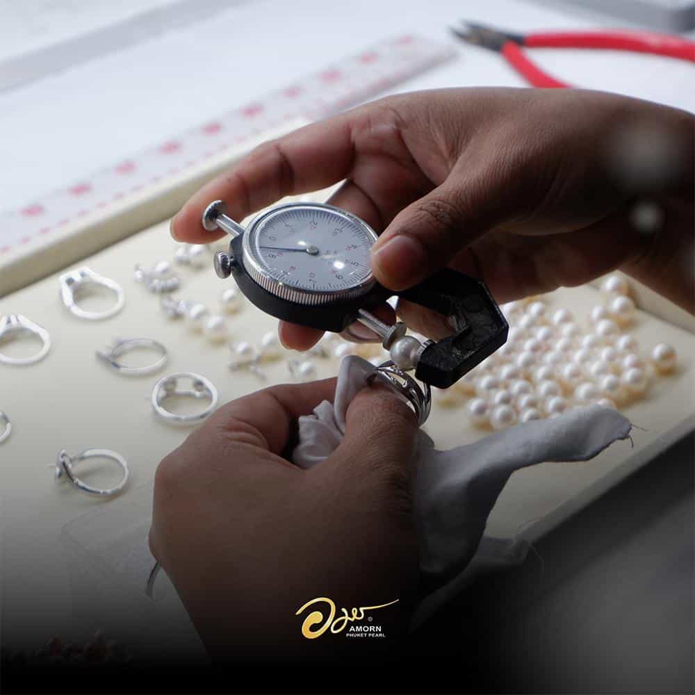 Pearls being carefully sorted and graded at a pearl farm in Phuket.